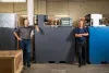 Rick Winter (left) and Gary Yang, founders of the former UniEnergy Technologies, stand with one of their latest batteries,