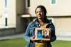 Meseret Haile displays a photo of her son Leoul outside her apartment in Bellevue. Leoul, who has special needs, is in a