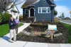 Britt Stromberg and neighbor Bob Wohl stand next to the
    pollution-fighting rain garden that fills half of Stromberg's