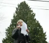 Sandy Shettler, from Tree Action Seattle, speaks to a crowd in February 2024 in front of Astra, a 100-year-old Western Red