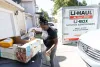Vancouver, Washington, resident ShaWayne Hodges takes out recycling while packing her home in preparation to move in late