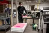 Election office employees put away sample ballots during the conclusion of a during a ballot-counting test at the Multnomah