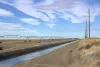 A pivot irrigation system with a drainage canal in the foreground. Water and nitrogen fertilizer is applied to crops using