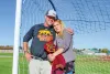 Travis and Erika Holmes look out over the soccer field where their son, Hunter Holmes, once played as the Redmond High