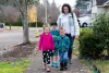Stephanie Shimp-Taylor walks her son Westen, 6, (center) home from Patterson Elementary School along with siblings Sawyer, 4