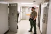A Clackamas County sheriff's deputy stands in the hall of the Clackamas County Jail on Tuesday, Jan. 22, 2019, in Oregon