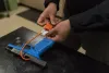 In this 2019 file photo, Sgt. Brandon White of the Multnomah County Sheriff's Office puts a cable lock on a training Glock