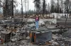 Climate activist Niria Garcia stands amid the burned-out remains of her father's home in Phoenix, Ore. His house and the
