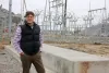 Gary Ivory, general manager of the Douglas County PUD, stands in front of the work-in-progress hydrogen plant being built