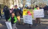 Demonstrators march around the Oregon Capitol Saturday, Jan. 14, 2017, in opposition to President-elect Donald Trump's