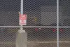A ‘no trespassing’ sign on a fence outside the Northwest Detention Center.