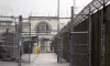 In this Jan. 28, 2016, file photo, a man does maintenance work between razor wire-topped fences at the Monroe Correctional