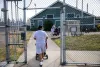 Christina Torres pushes her baby Janessa through the grounds to the Early Head Start learning center at the Washington