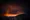 The glow of sodium vapor lights mixes with clouds above the Grand Coulee Dam, presenting an ominous glow resembling what an