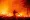 A firefighter douses flames as they push towards homes during the Creek fire in the Cascadel Woods area of unincorporated