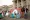 Eddie Melendrez, a Chicano artist, speaks in a megaphone while showcasing his mural representing the United Farmworkers of